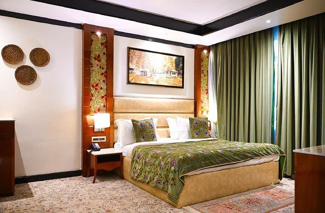 Crewel embroidered bed ensemble in a suite