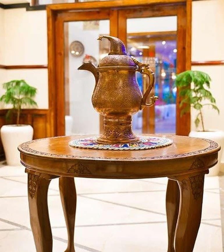 Copper samawaar on a carved walnut table
